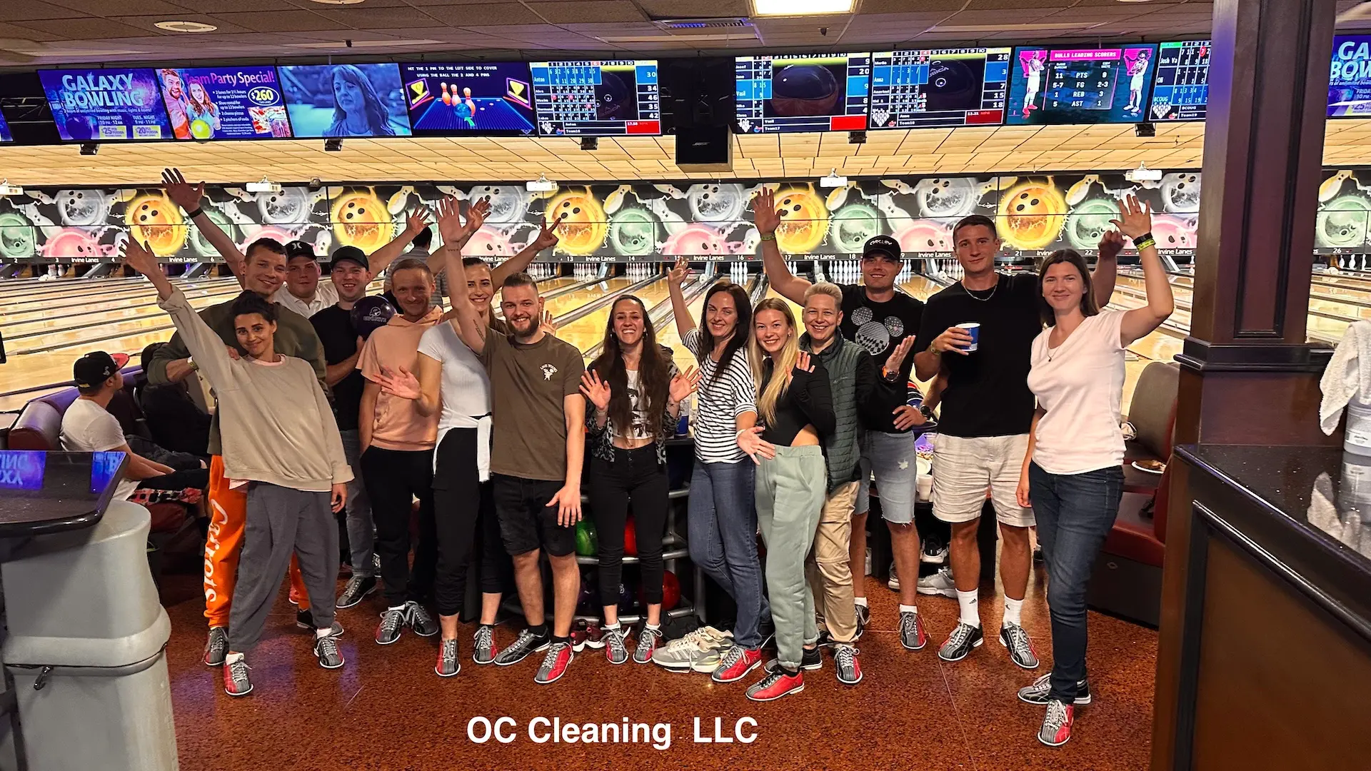 Our cleaning company team waving at the bowling alley